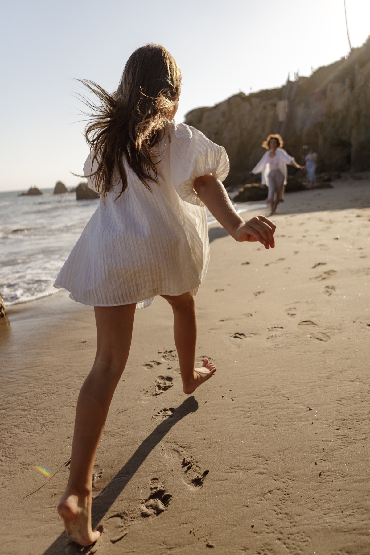 Person running on the beach at sunset
