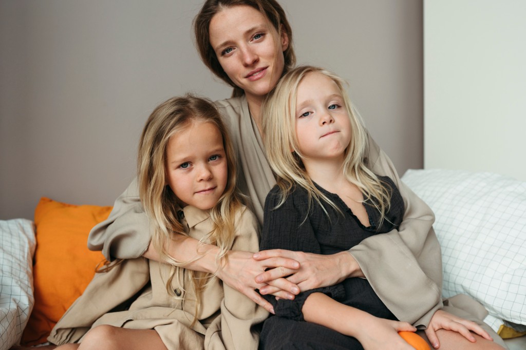 Mother sitting with her children on a couch