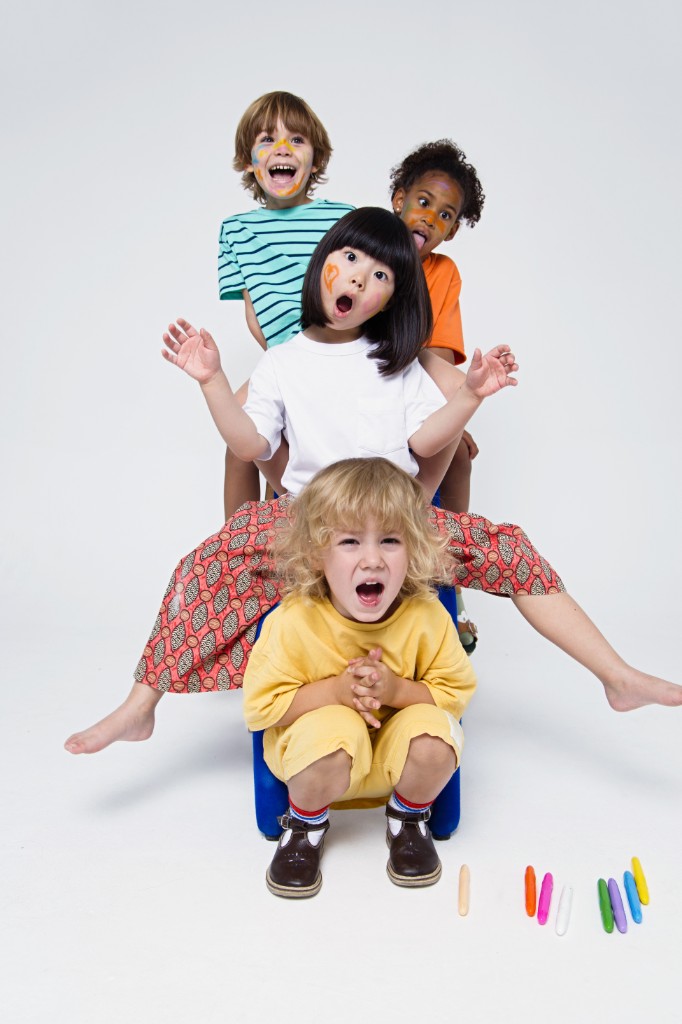 Group of children playing and stacked together in a studio